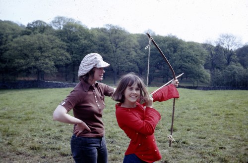 Daphne Neville teaching Lesley Bennett to shoot the longbow